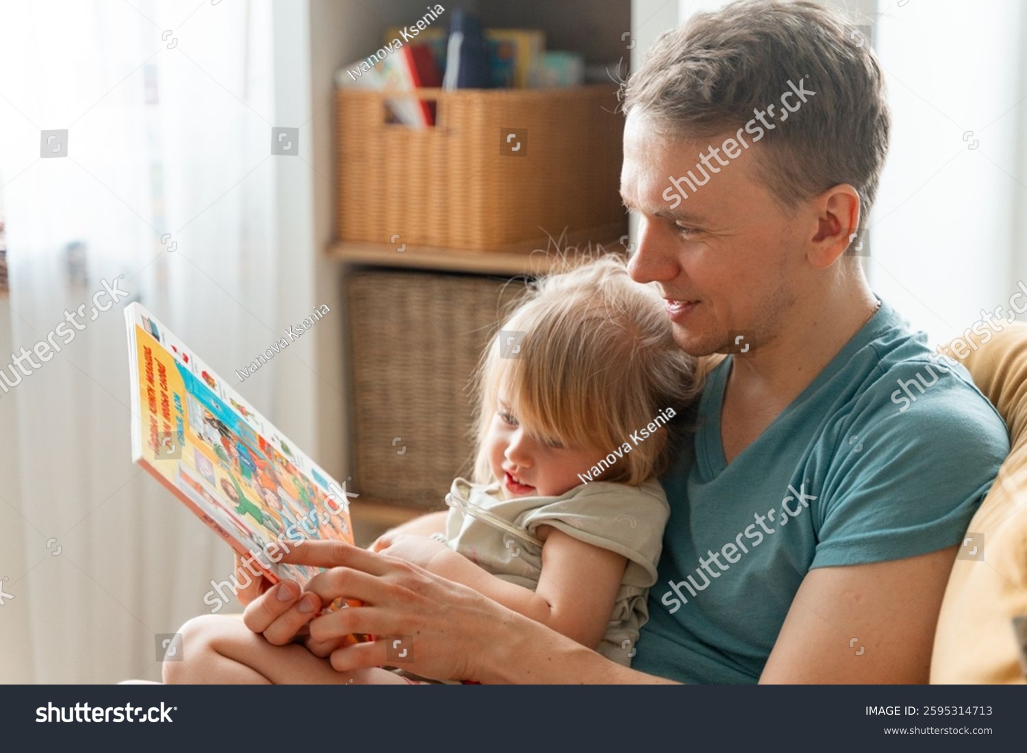 stock-photo-a-father-reads-a-book-to-a-sick-child-with-a-thermometer-under-his-arm-saint-petersburg-russia-2595314713